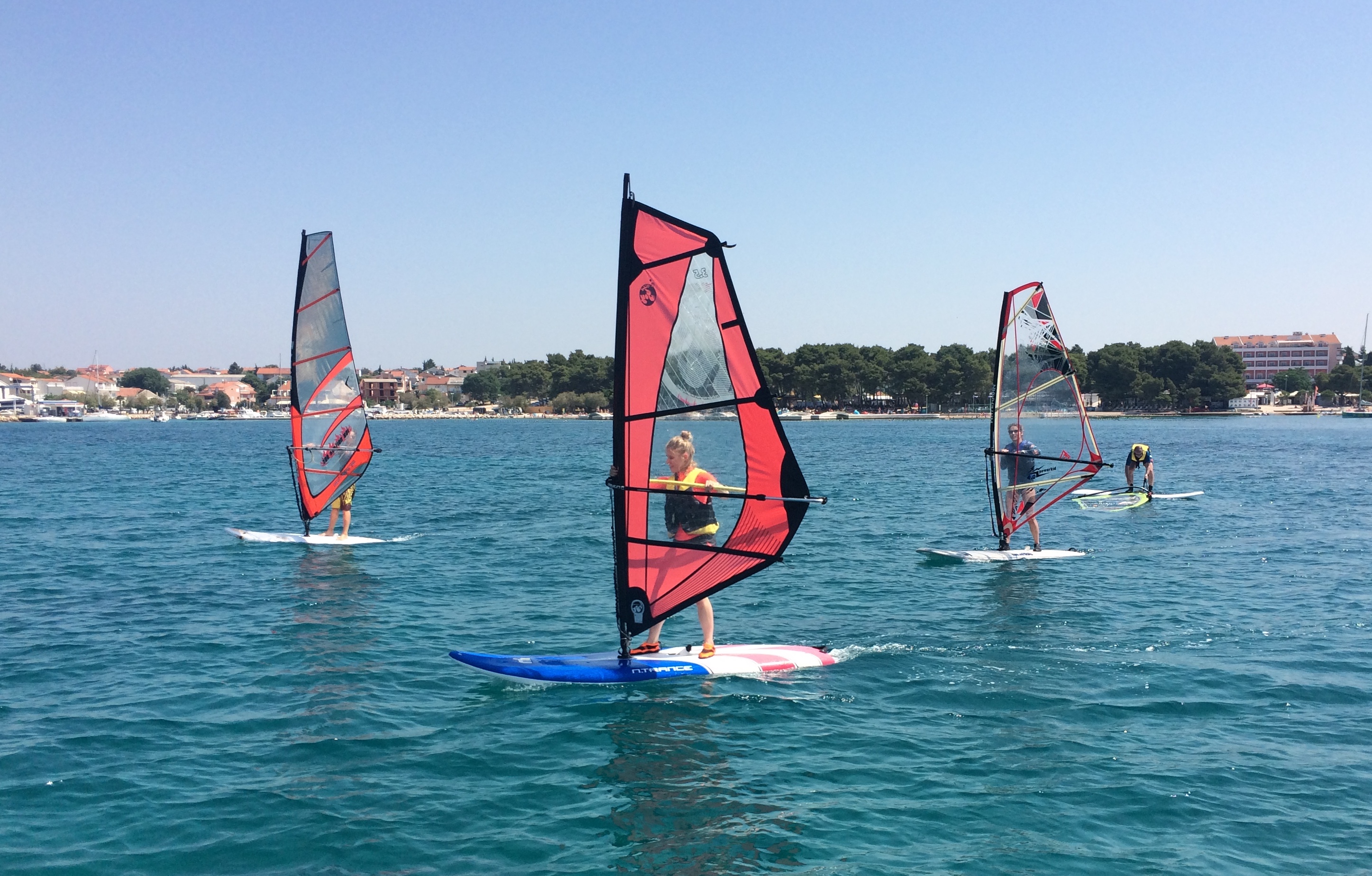 A group of adventurous people learning to windsurf with Bluewind